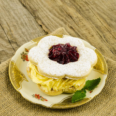 Cake with cream on wooden table