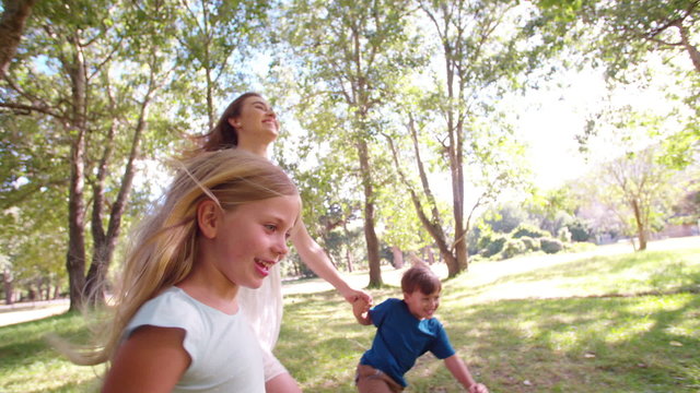 Fun Mom And Her Children Running Freely In A Field