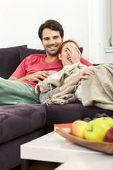 Couple Resting on the Sofa at the Living Room