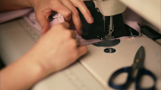 Woman is Sewing Clothes