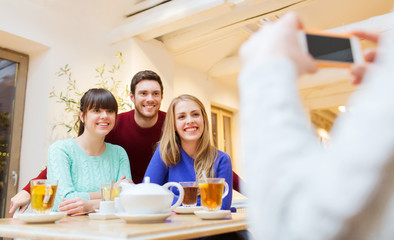 group of friends taking picture with smartphone