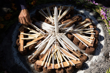 hand adding candle to shamanic fire ring