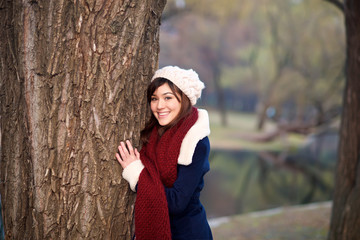 Beautiful girl hugging tree