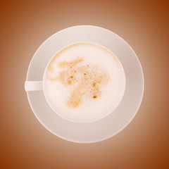 Coffee cup with cappuccino on brown background