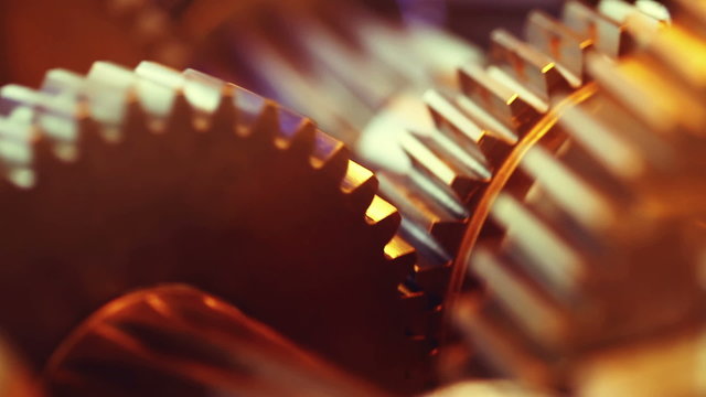 Golden gears with cogs in action. HD 1080p, Loop-ready