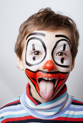 little cute real boy with facepaint like clown, pantomimic expre