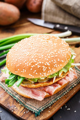 Burger with potato pancake and bacon