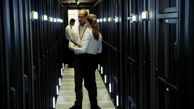 Team of IT engineers working in a data centre