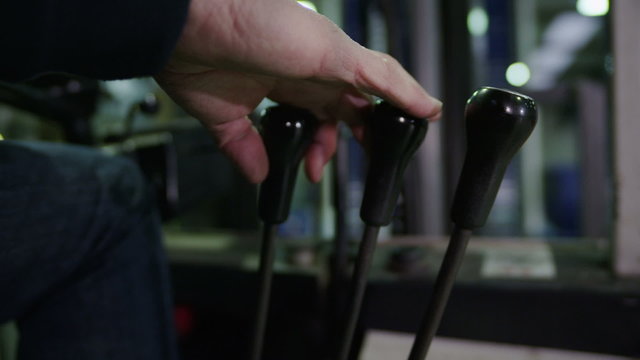 Close up of the hand of a forklift truck driver changing gear