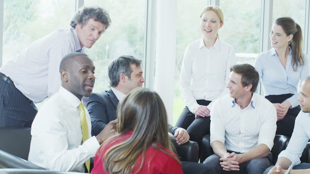 Casual And Informal Business Meeting, Colleagues Sit Together And Share Ideas