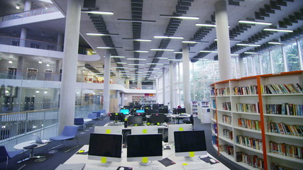Interior view of the library in a large modern university building. No people