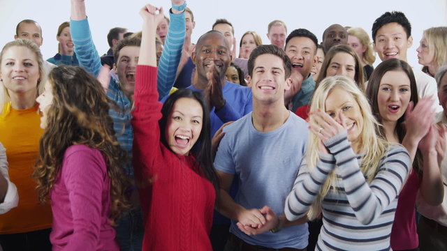 Happy, diverse group in casual clothing smiling and clapping