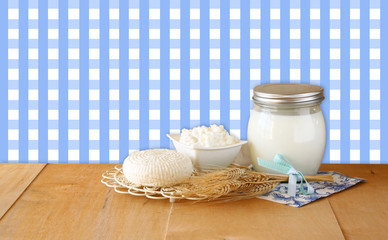 Tzfatit cheese , cottage and milk on wooden table over retro rur