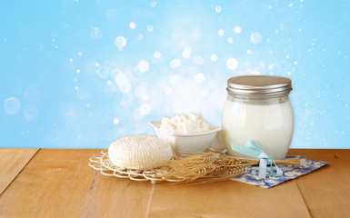 Tzfatit cheese , cottage and milk on wooden table over blue glit