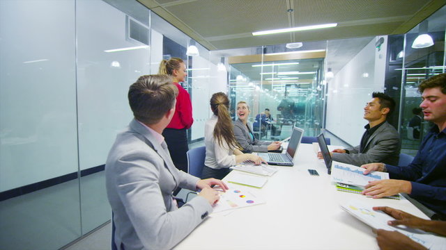 Attractive young business team in a meeting in modern city office. 