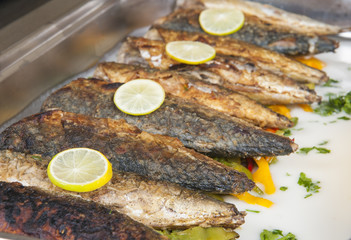 Grilled mackerel fish at a buffet