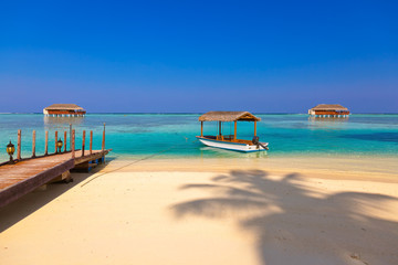 Boat and bungalow on Maldives island