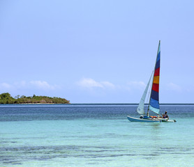 Naklejka premium Colorful catamaran on azure water