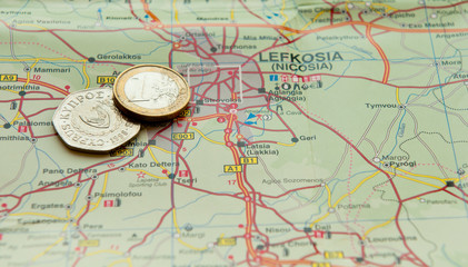Fototapeta na wymiar Euro coin and Cyprus cents on a map