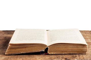 Opened old book on a wooden table