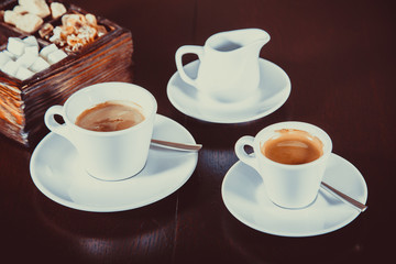 Coffee, milk and sugar on wooden surface , toned