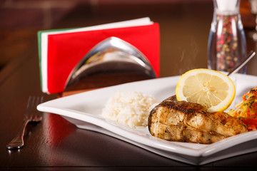 grilled fish and rice with many vegetables
