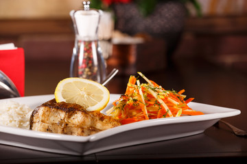 grilled fish and rice with many vegetables