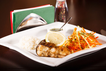 grilled fish and rice with many vegetables
