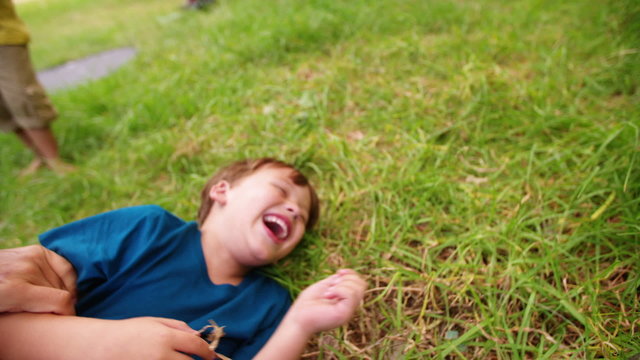 Happy boy laughing as he is being tickled