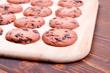 Delicious chocolate chip cookies on the board top view