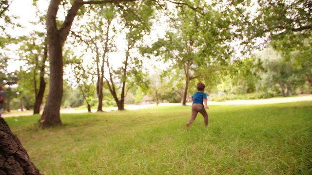 Adventurous Little Boy Running In Park Exploring Nature