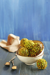 Tasty homemade pistachio candies on wooden table