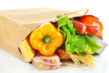 Shopping bag with set of products isolated on white background