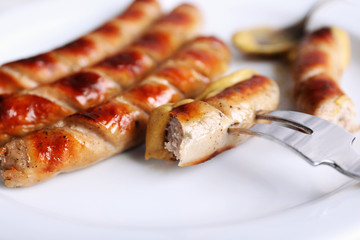 Grilled sausages on plate close up