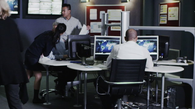Security team watching the screens in control center office