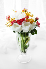 Beautiful spring bouquet in vase on windowsill