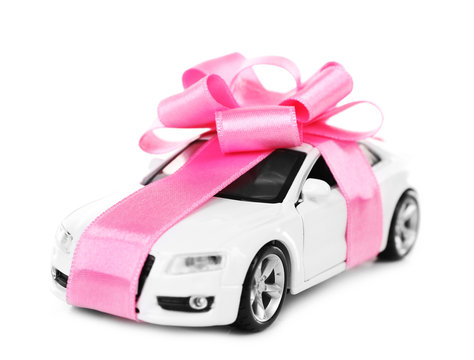 New Car With Pink Bow As Present Isolated On White