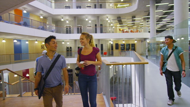 Diverse student group in a large modern university building.