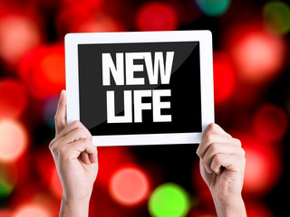 Tablet pc with text New Life with bokeh background