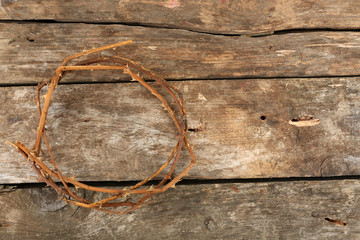 Crown of thorns on old wooden background