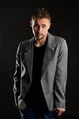 Fototapeta premium portrait of young negligent man on dark background