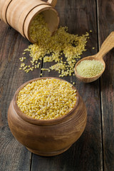 Bulgur and couscous in wooden pots