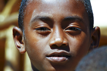 Very handsome african boy with shadow on his face, poverty in Ma