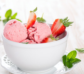strawberry ice cream and leaves of mint