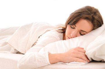 Obraz na płótnie Canvas sleeping young woman in white