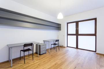 Gray desks in empty interior