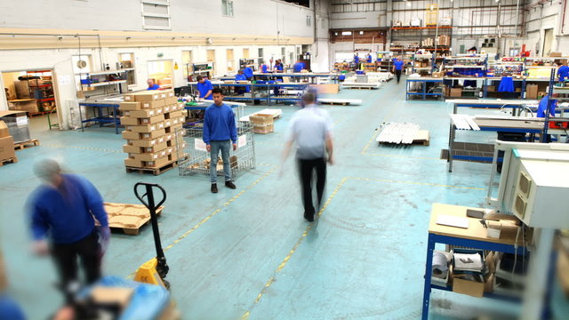 Time lapse of male workers in warehouse preparing goods for dispatch
