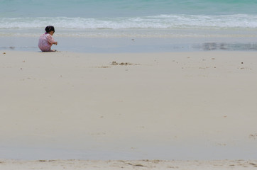 Little asian girl on the beach