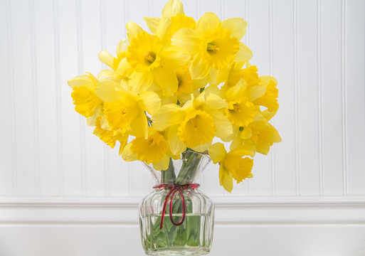 Daffodils in a vase in rustic setting - horizontal