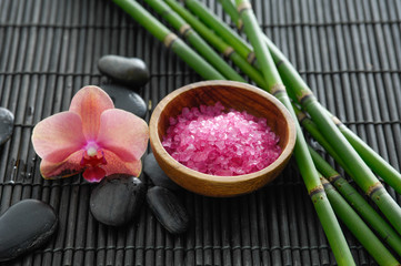 Obraz na płótnie Canvas SPA setting with orchid ,salt in bowl,stones,grove